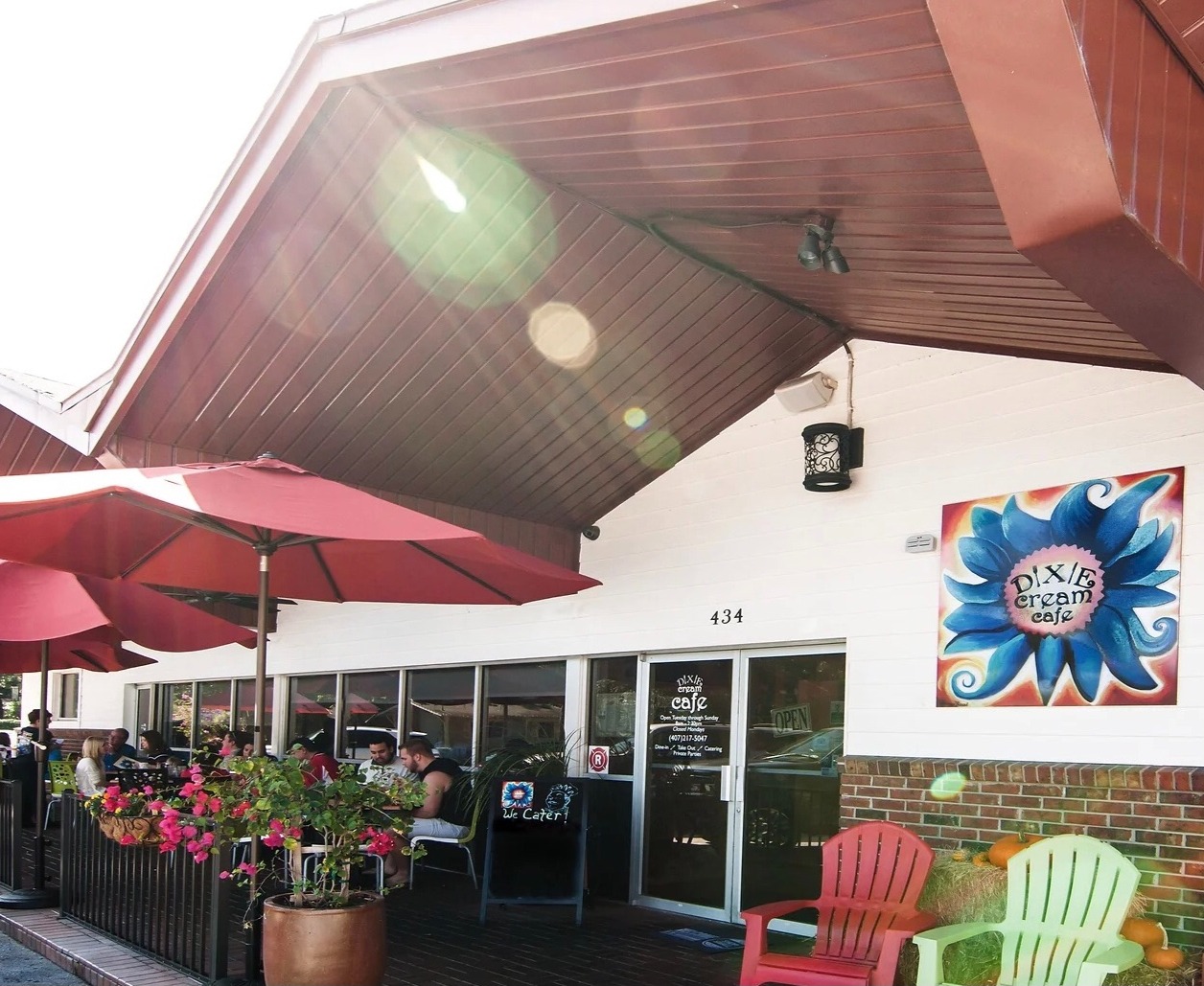 Dixie Cream Cafe storefront with colorful chairs and red umbrellas